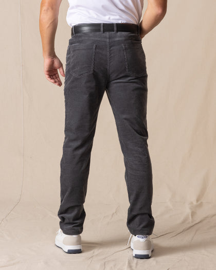 Men's Smithson Corduroy Pant in Walrus, back on-model view featuring two patch pockets in charcoal gray corduroy, styled with a white t-shirt, black leather belt, and white shoes