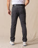 Men's Smithson Corduroy Pant in Walrus, back on-model view featuring two patch pockets in charcoal gray corduroy, styled with a white t-shirt, black leather belt, and white shoes