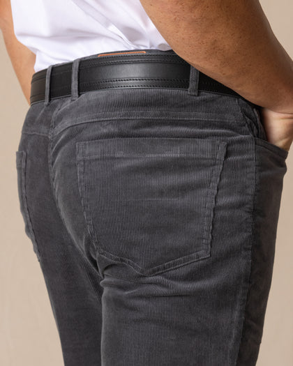 Men's Smithson Corduroy Pant in Walrus, close-up detail view of the back patch pocket and waistband featuring fine wale corduroy texture, styled with a black leather belt with tan buckle accent