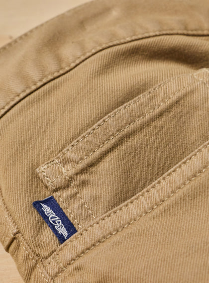 Men's Henderson 5 Pocket Pant in Bronze, close-up interior pocket detail featuring a woven logo tab and tonal topstitching