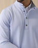 Men's Hollister Snap Placket Pullover in Powder, on model front close-up view featuring waffle-knit texture detail, gunmetal snap button placket, and stand collar worn over a white polo