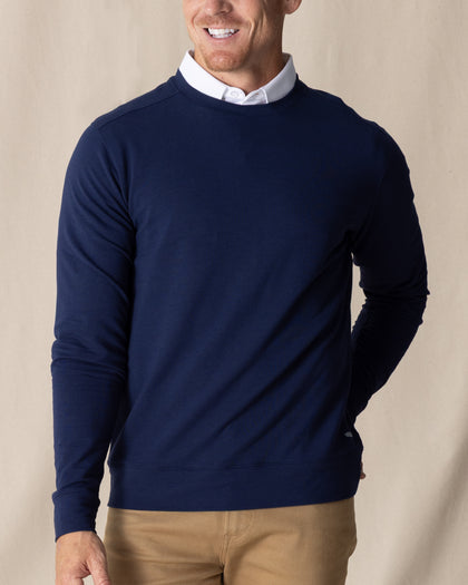 Men's Nathan 2.0 Crew in New Indigo, front view on male model layered over a white collar, paired with khaki pants against a neutral linen backdrop