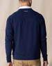Men's Nathan 2.0 Crew in New Indigo, back view on male model showing embroidered logo at center back neck and ribbed hem, paired with khaki pants