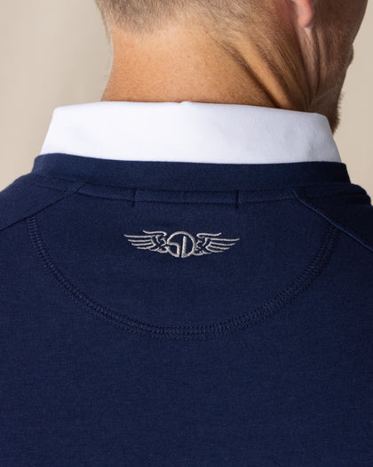 Men's Nathan 2.0 Crew in New Indigo, close-up detail of embroidered winged logo at center back neck with white polo collar visible above