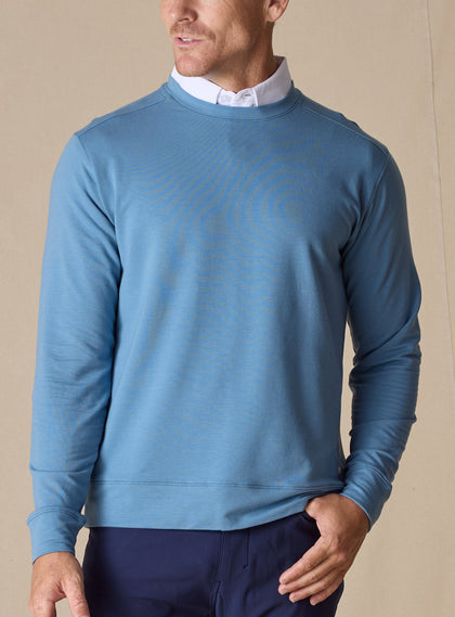 Men's Nathan 2.0 Crew in Petrol, front view on male model layered over a white collar, paired with navy pants against a neutral backdrop