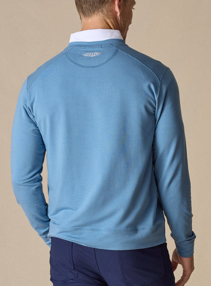 Men's Nathan 2.0 Crew in Petrol, back view on male model showing embroidered logo at center back neck and ribbed hem, paired with navy pants