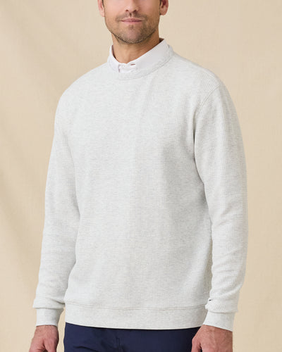Model wearing the Hopkins Crew in Heather layered over a white collared polo.