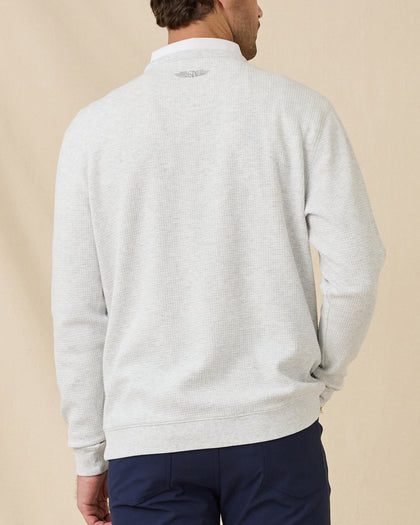 Model wearing the Hopkins Crew in Heather, showing the textured knit and embroidered logo below the back neckline.