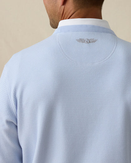 Close-up of back neck showing subtle embroidered Straight Down winged logo on light blue pullover.