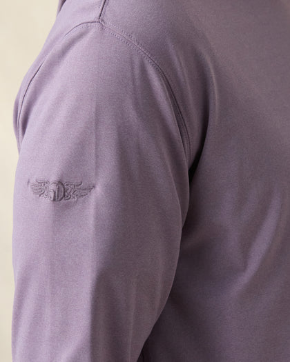 Close-up of a purple long-sleeve shirt with a purple logo on the sleeve