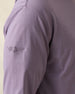 Close-up of a purple long-sleeve shirt with a purple logo on the sleeve