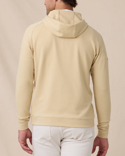 Back view of a model wearing the Gridlock Hoodie in Sandstorm, showing the hood and textured waffle knit.