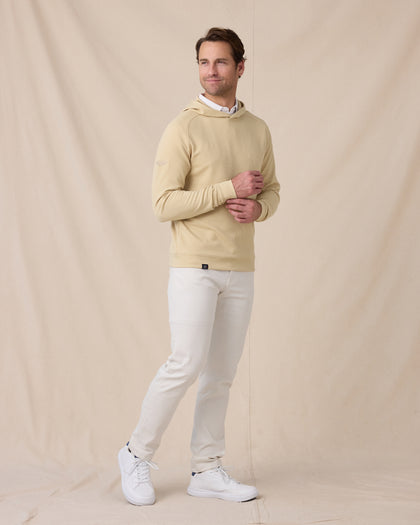 Full-length view of a model wearing the Gridlock Hoodie in Sandstorm with white pants and white sneakers.