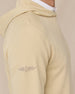 Close-up of the Gridlock Hoodie in Sandstorm highlighting the waffle knit texture, raglan shoulder seam, and embroidered sleeve logo.