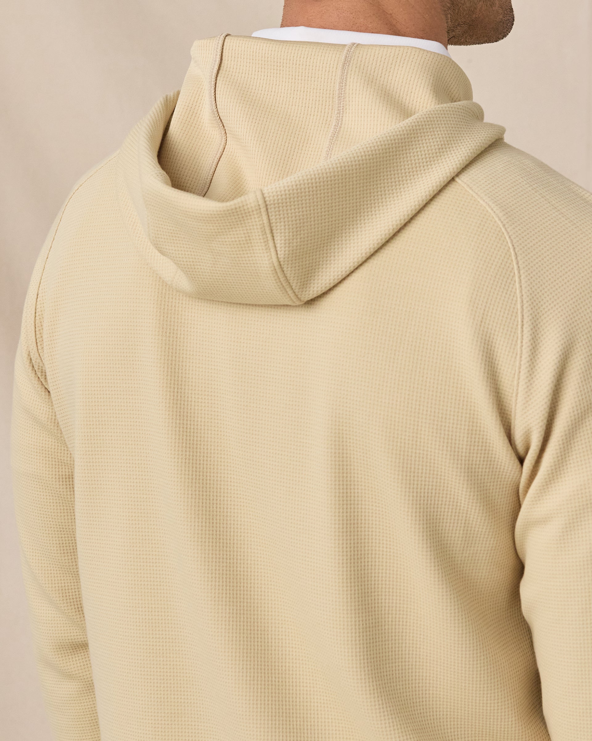 Close-up back view of the Gridlock Hoodie in Sandstorm highlighting the hood construction and textured waffle knit.