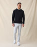 Men’s Gridlock Hoodie in black, full-body on-model view styled with light pants