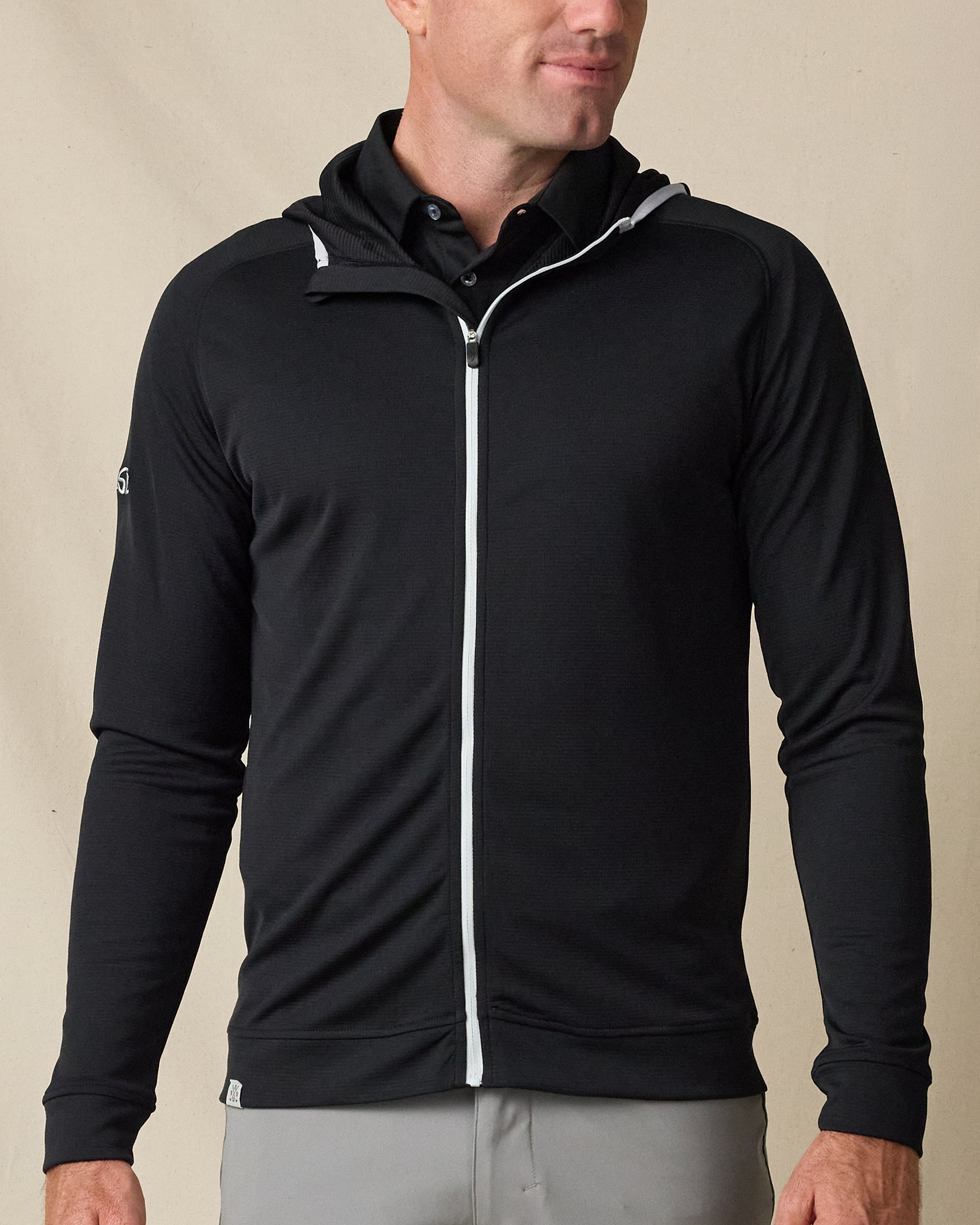 Model wearing the Condor Full Zip Hoodie in Black, featuring a full-zip front, hood, and contrast zipper detailing.