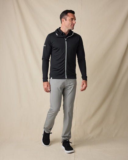 Model wearing the Condor Full Zip Hoodie in Black with gray pants and black sneakers.