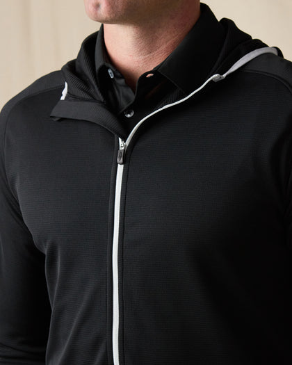 Close-up of the Condor Full Zip Hoodie in Black, featuring a textured finish, contrast white zipper, and hood.
