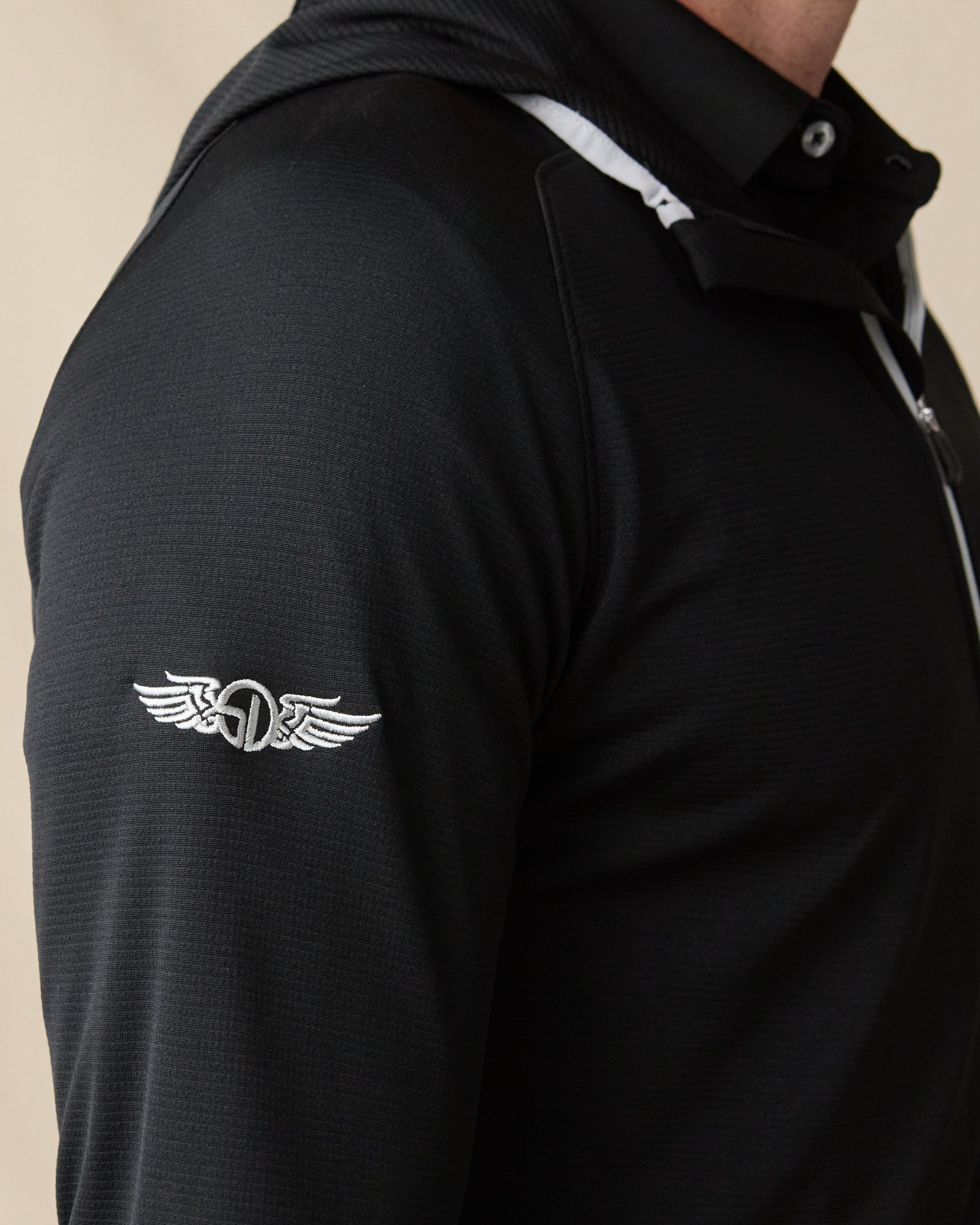 Close-up of the Condor Full Zip Hoodie in Black, highlighting the embroidered Straight Down logo on the sleeve and contrast hood trim.