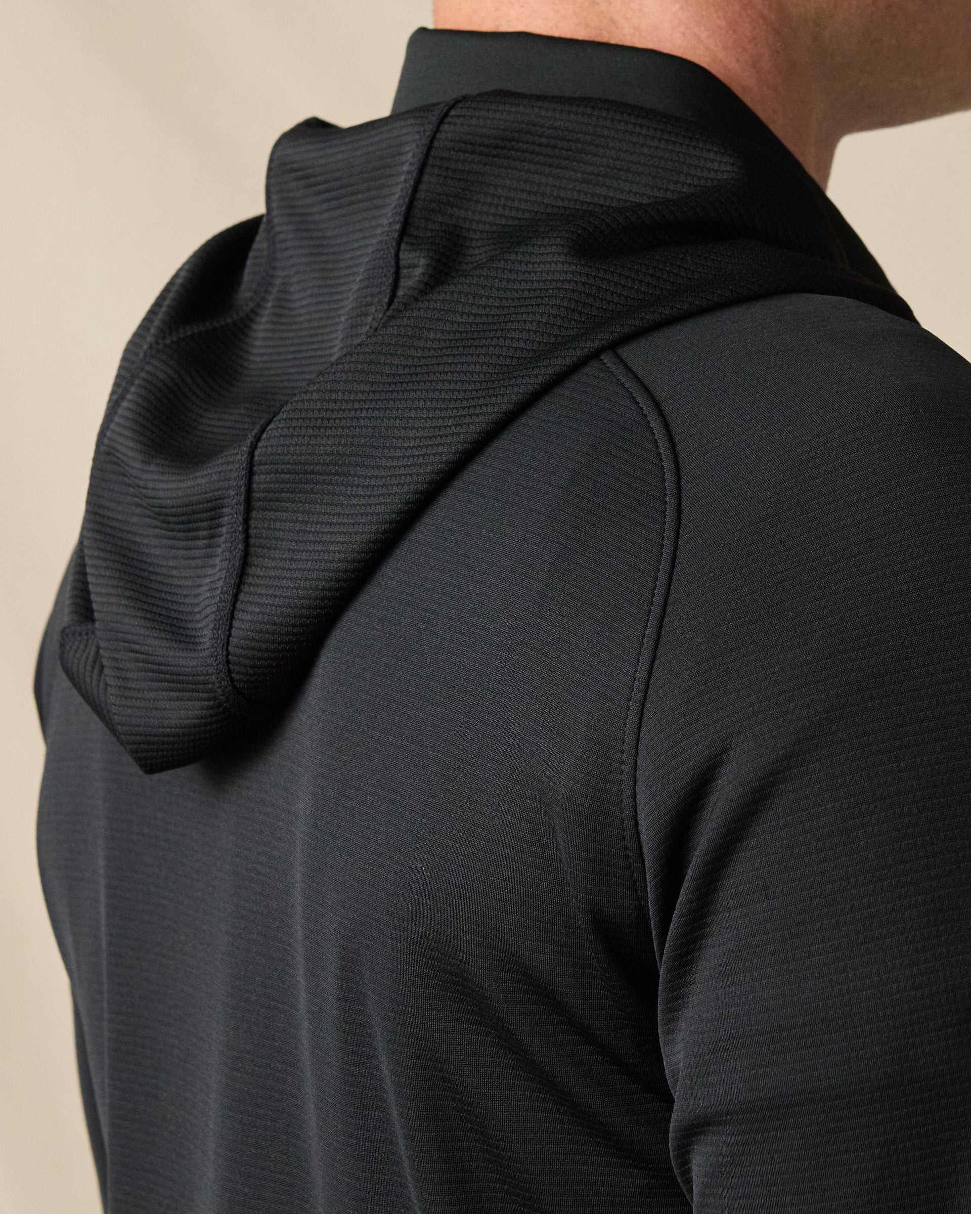 Close-up of the back of the Condor Full Zip Hoodie in Black, highlighting the textured hood and streamlined shoulder construction.