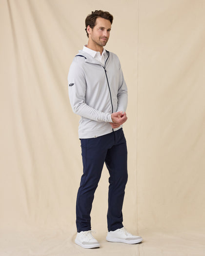 Model wearing the Condor Full Zip Hoodie in Silver with navy golf pants