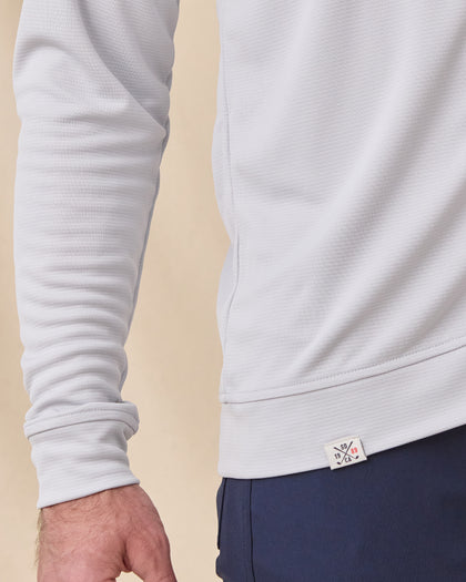 Close-up of the Condor Full Zip Hoodie in Silver showing the textured dobby knit fabric, sleeve construction, and hem detail