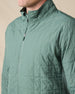 Close-up of the Big Sky Quilted Jacket in Dark Forest, featuring grid quilting, a full-zip front, and stand collar.