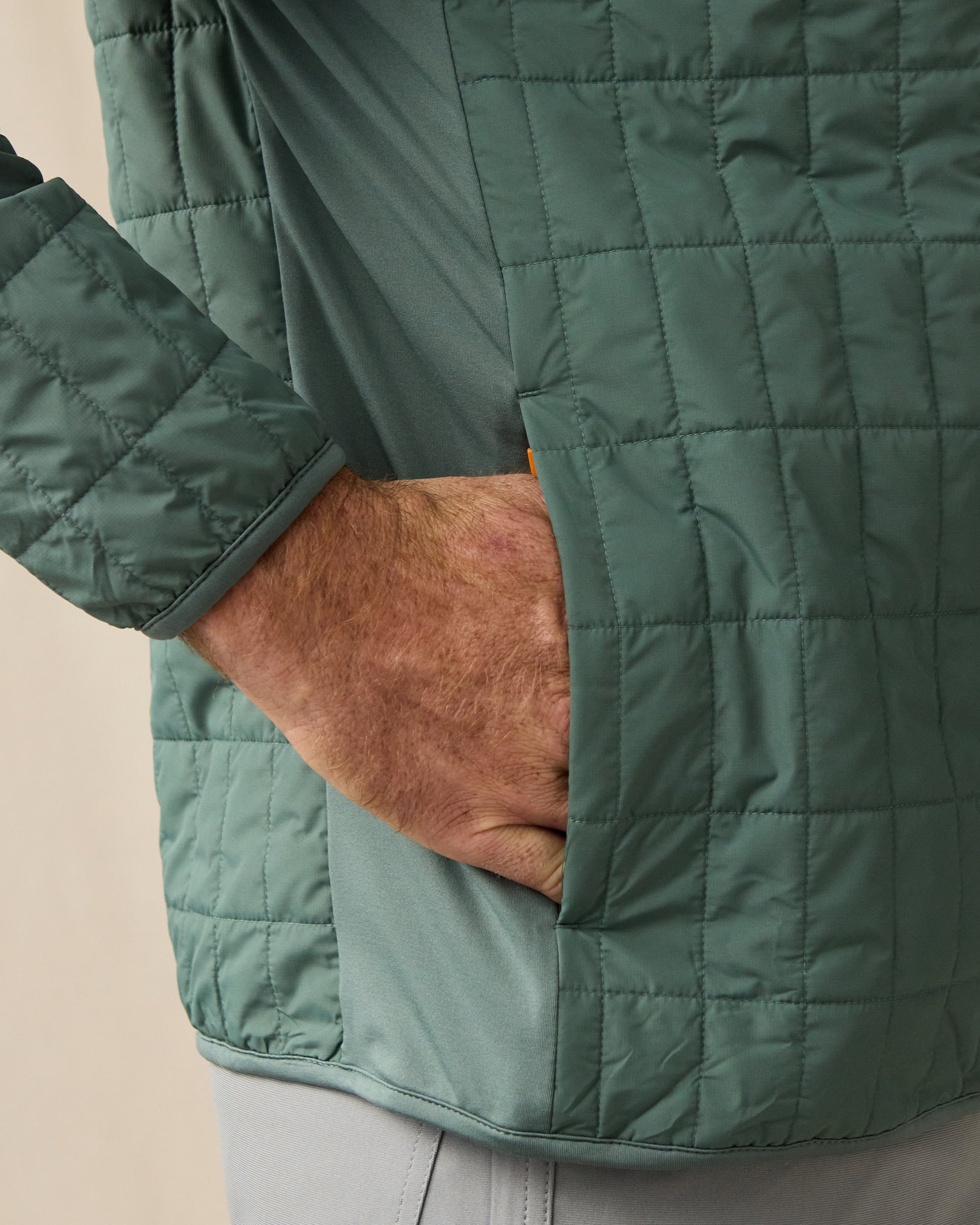 Close-up of the Big Sky Quilted Jacket in Dark Forest, highlighting the grid quilting, stretch side panel, and hand pocket.
