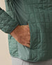 Close-up of the Big Sky Quilted Jacket in Dark Forest, highlighting the grid quilting, stretch side panel, and hand pocket.