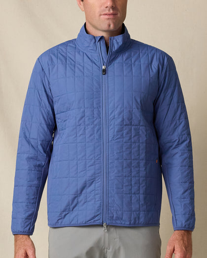 Model wearing the Big Sky Quilted Jacket in Moonlight, featuring grid quilting, a full-zip front, and stand collar.