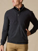 Men's Harding Hybrid Quarter Zip in Black, front view on male model showcasing solid black upper panel with chest zip pocket and quarter zip, layered over a dark polo, paired with khaki pants against a neutral backdrop