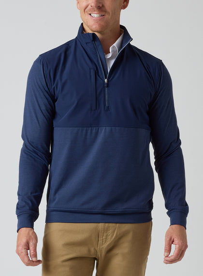 Men's Harding Hybrid Quarter Zip in New Indigo, front view on male model showcasing dual-fabric navy paneling with quarter zip, layered over a white polo, paired with khaki pants
