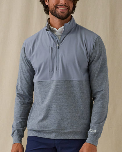 Men's Harding Hybrid Quarter Zip in Storm, on model front view featuring a solid steel grey upper body with heathered charcoal grey lower body and sleeves, chest zip pocket and quarter zip detail