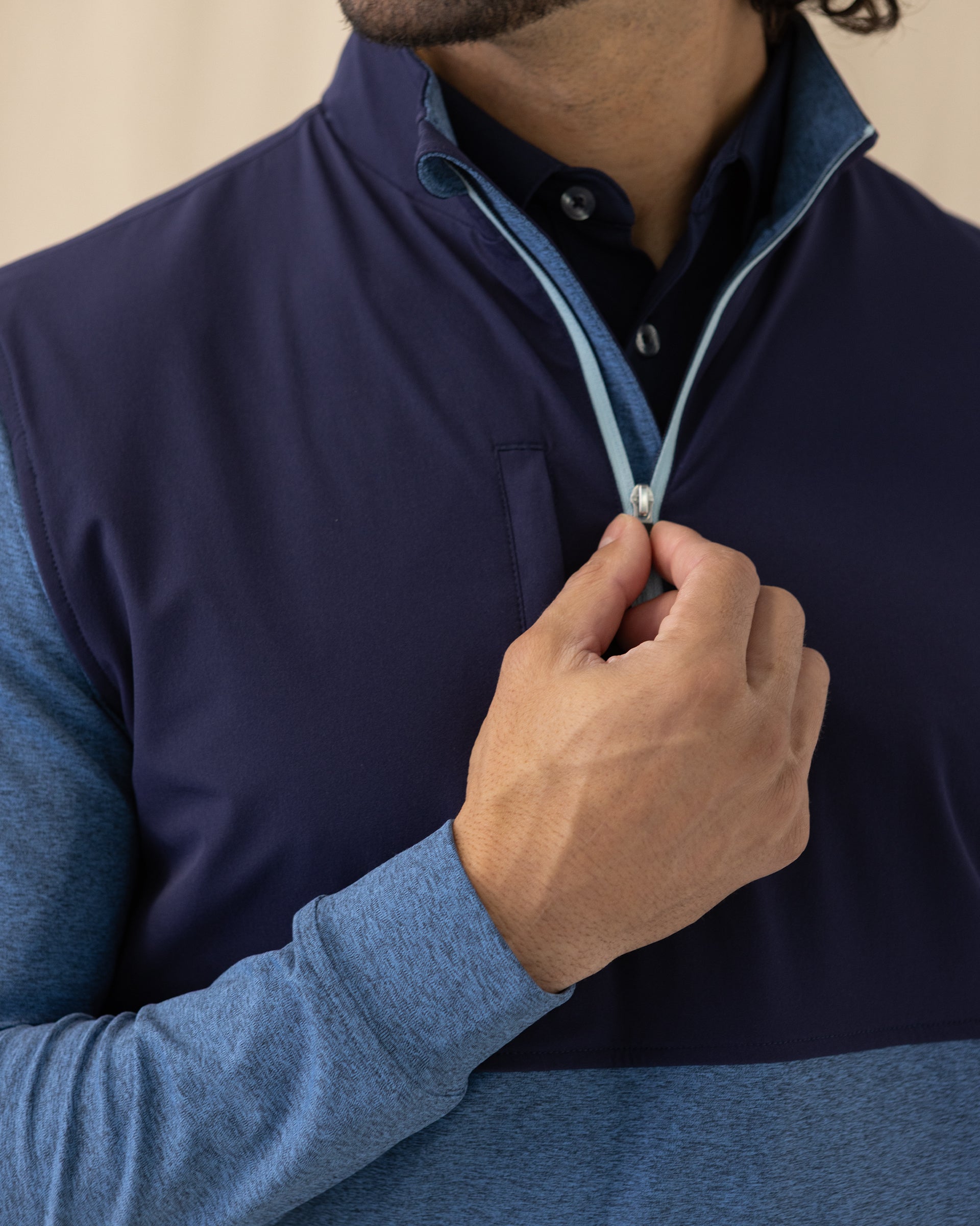 Men's Harding Hybrid Quarter Zip in Bering, close-up front view featuring the navy performance upper body with a light blue quarter zip detail and chest zip pocket