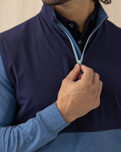 Men's Harding Hybrid Quarter Zip in Bering, close-up front view featuring the navy performance upper body with a light blue quarter zip detail and chest zip pocket