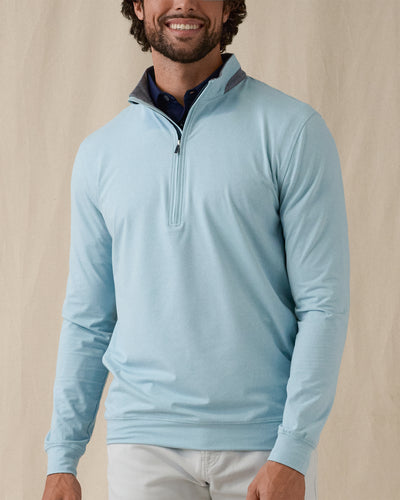 Men's Cimarron Quarter Zip in Delphinium, front view on male model showcasing soft sky blue body with grey heathered collar and quarter zip, layered over a navy polo against a neutral backdrop