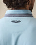 Men's Cimarron Quarter Zip in Delphinium, close-up detail of embroidered winged logo at center back neck with grey heathered collar visible above