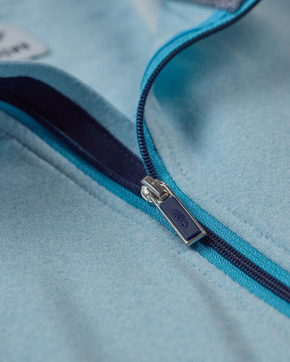 Men's Cimarron Quarter Zip in Delphinium, close-up detail of branded navy zip pull with teal and navy contrast zipper tape