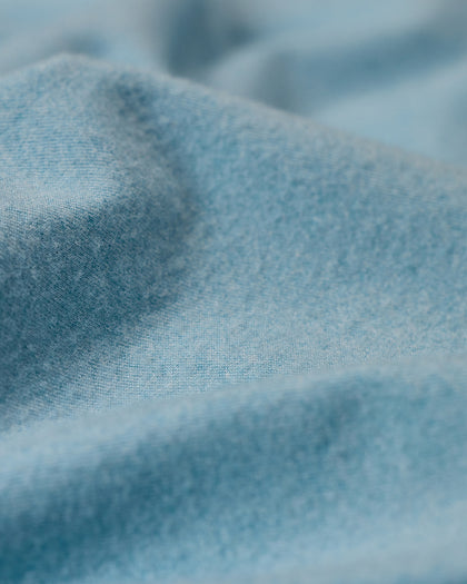 Men's Cimarron Quarter Zip in Delphinium, close-up fabric detail showing the soft sky blue color and heathered texture