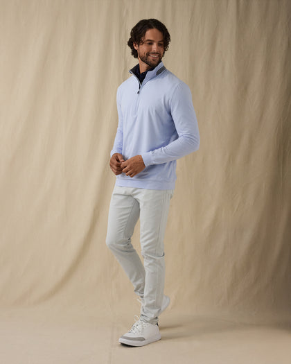 Men's Cimarron Quarter Zip in Lavender, full-length side view on male model styled with light grey pants and white golf shoes against a neutral linen backdrop