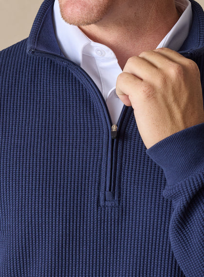 Men's Cambria Quarter Zip in New Indigo, close-up detail view of the quarter zip closure and ribbed knit fabric texture with navy interior collar, layered over a white collared shirt