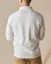 Men's Cambria Quarter Zip in Stone, back on-model view featuring a cream white ribbed knit fabric with an embroidered Straight Down logo at the yoke, styled with tan pants