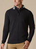 Men's Catalina Quarter Zip in Black, front on-model view featuring a black ribbed fabric with a quarter zip closure and gray interior collar, styled with tan pants