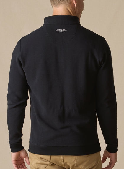 Men's Catalina Quarter Zip in Black, back on-model view featuring a black ribbed fabric with an embroidered Straight Down logo at the yoke, styled with tan pants