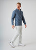 Men's Catalina Quarter Zip in Deep Sea, side on-model view featuring a slate blue ribbed fabric with a quarter zip closure and Straight Down woven label at the hem, styled with white pants and white shoes