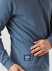 Men's Catalina Quarter Zip in Deep Sea, close-up detail view of the side seam pocket and Straight Down branded woven label reading "Designed for Sport, Crafted for Life"