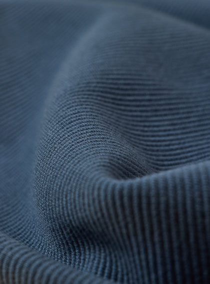 Men's Catalina Quarter Zip in Deep Sea, macro detail view showcasing the soft ribbed texture and tonal horizontal stripe pattern of the slate blue fabric