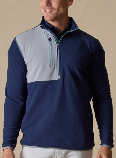 Men's Moonstone Quarter Zip in New Indigo, front model view featuring a navy micro-fleece body with gray contrast chest panel and light blue zipper tape