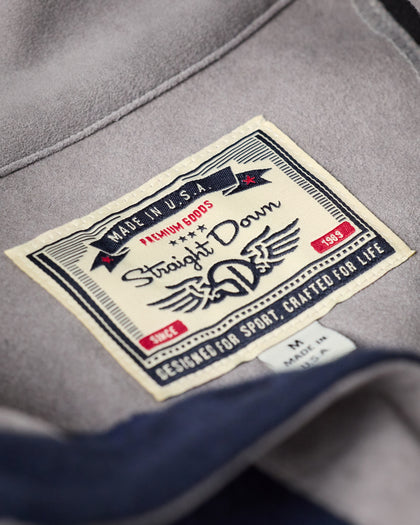 Men's Leucadia Quarter Snap Pullover in Indigo, close-up of interior woven label featuring Made in U.S.A. branding, Premium Goods designation, and Designed for Sport, Crafted for Life tagline
